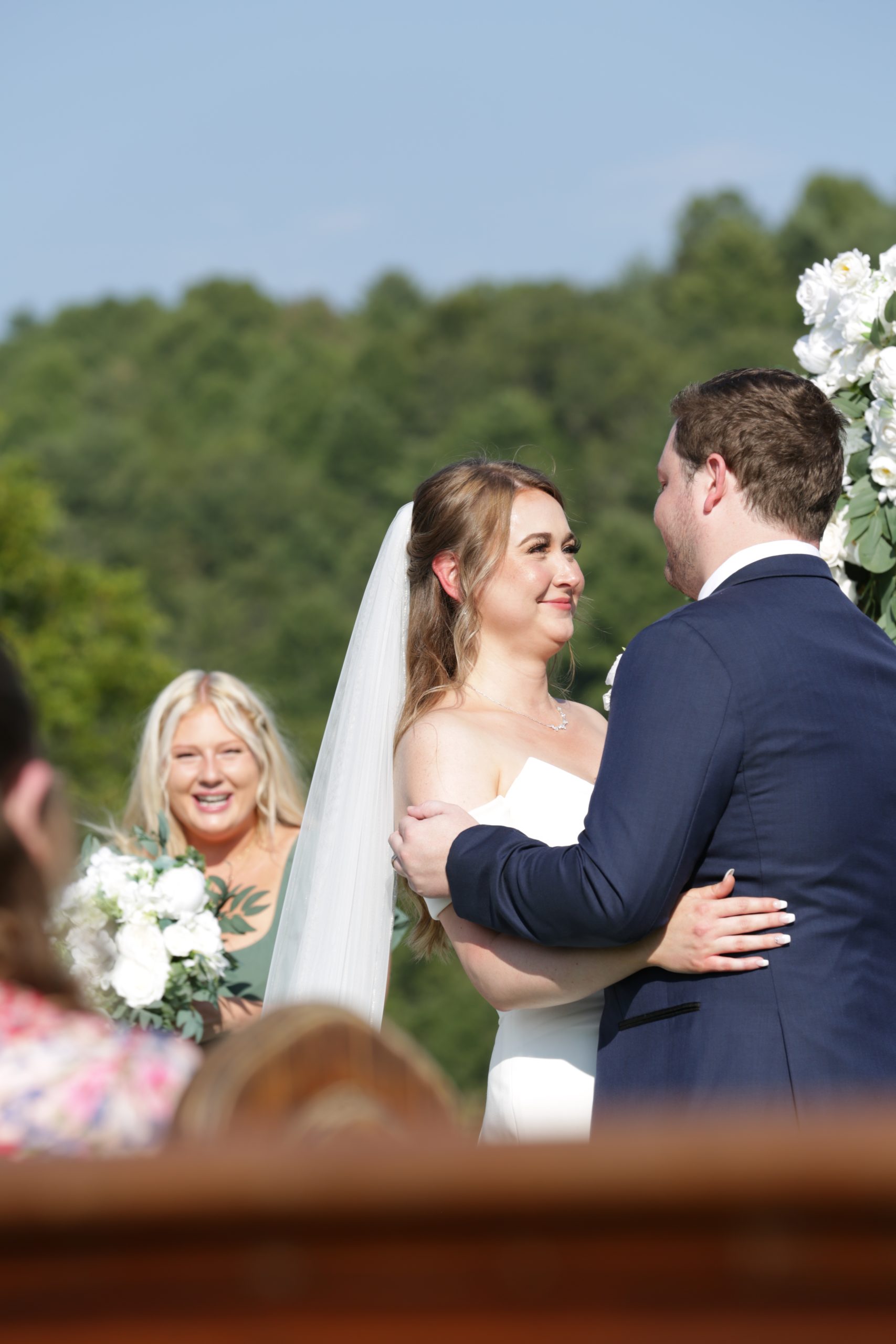 Image of woman embracing her newly wed husband man during wedding ceremony
